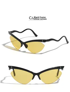 Detail of rimless cat-eye sunglasses with wavy black temples and yellow tinted lenses