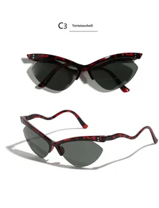 Detail of tortoiseshell cat-eye sunglasses with unique wavy temples and dark lenses