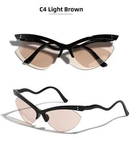 Macro shot of rimless butterfly cat-eye sunglasses with wavy temples and light brown lenses