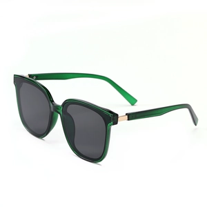 Retro oversized cat-eye sunglasses with translucent emerald green frames and gold hinges