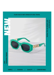 Detail of green thick frames with gold chain links and dark lenses for stylish sunglasses