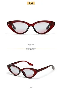 Detailed view of wine red cat eye sunglasses with pink gradient lenses and metal rivets