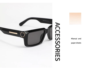 Detail of Y2K square sunglasses with thick black frames and gold hexagon temple accents