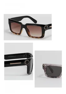 Detail view of square Y2K sunglasses featuring rivet accents and gold temple hardware