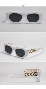 Detail view of white square sunglasses featuring oversized gold metal chain temples