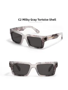 Detail of square milky grey tortoiseshell sunglasses with gold metal temples