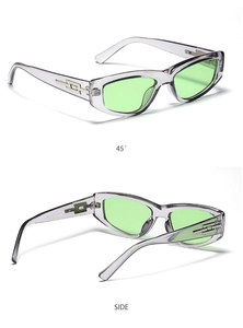 Detail view of cat eye sunglasses with gray frame and gold geometric temple hardware
