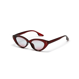 Retro cat eye sunglasses with reddish-brown transparent frame and rivet details