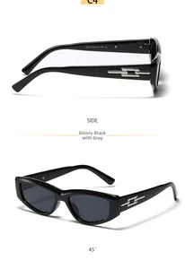 Detail view of black cat-eye sunglasses with silver H-shaped temple decor and gray lenses