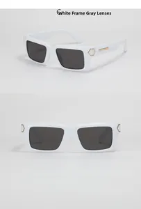 Detail view of Y2K white square sunglasses with deep grey lenses and gold metal accents