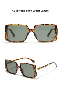 Detail of tortoise frame and dark green lenses with golden metal hinge decorations