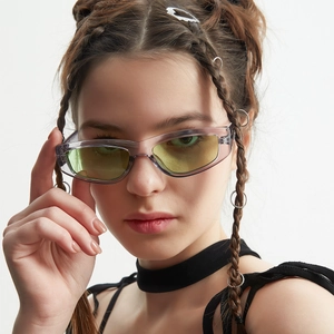 Retro slim cat eye sunglasses with purple frames and yellow-green lenses on a model