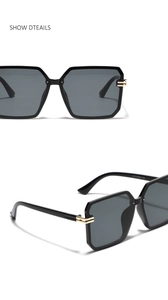 Detail of square black sunglasses with golden metal accents and lens specifications