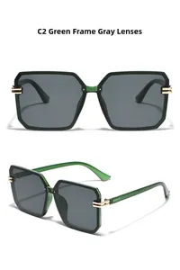 Detail view of square green sunglasses with dark grey lenses and golden metal accents