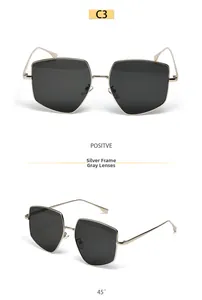 Detail view of large polygon silver metal sunglasses with grey lenses in high definition