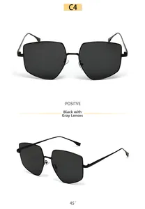 Detail view of black oversized polygon sunglasses with grey lenses in metal frame