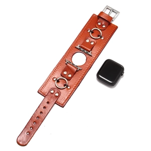 Close-up of vintage brown leather smartwatch band with wide base and silver metal studs