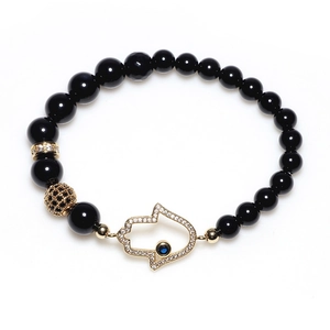 Black agate beaded bracelet with Hamsa hand pendant and hollow gold filigree bead