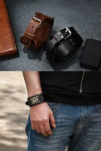 Detail of punk wide leather bracelet with vintage gold metal plate and buckle closure