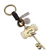 Detail of vintage bronze elephant keychain with braided leather strap and love charm