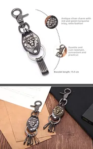 Detail view of vintage lion head keychain with leather cord showing dimensions 15.5cm