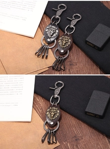 Detailed close-up of retro lion head keychain with leather strap and metal rings