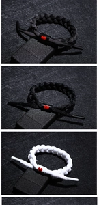 Detailed view of woven bracelets with reflective shoelace texture and red heart slider charm