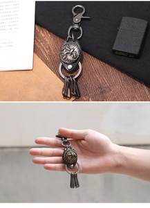 Detail view of retro horse head relief metal keychain with leather strap and hooks