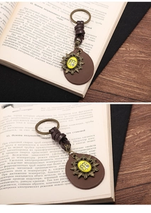 Macro shot of vintage Virgo zodiac keychain with braided leather cord and bronze finish