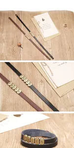 Gros plan de bracelets en cuir tressé vintage avec breloques Faith et fermoir bronze