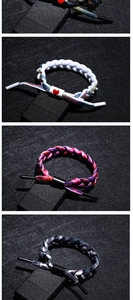 Detailed view of woven reflective shoelace bracelets in four vibrant color patterns