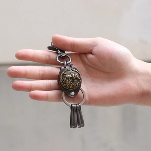 Vintage horse relief keychain with brass metal disc and brown leather base