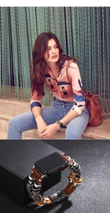 Detail of bohemian style leather watch band with vintage silver beads and colorful charms