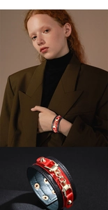 Detail view of fashion leather bracelet with gold chain and metal studs in punk style