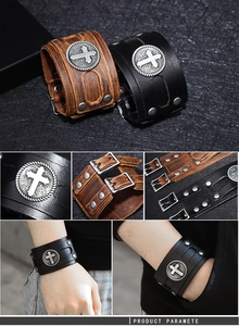 Detail of punk leather wristband showing cross metal badge and buckle closure