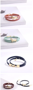 Close-up of double-wrap leather bracelet with golden dachshund charm in various colors