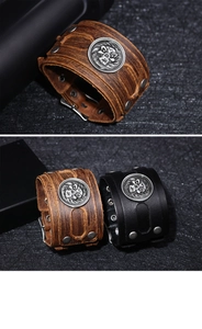 Macro shot of punk wide leather bracelet with flame skull metal emblem and silver rivets