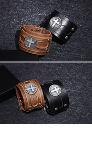 Close-up of vintage wide leather bracelet with embossed metal cross and rivet details