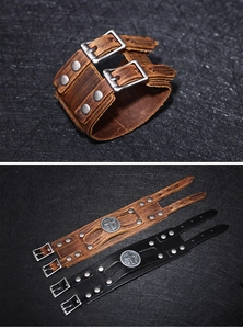 Detailed view of punk leather bracelets with rivets and cross emblems in black and brown