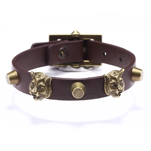 Vintage dark brown leather bracelet with bronze tiger head emblems and adjustable buckle