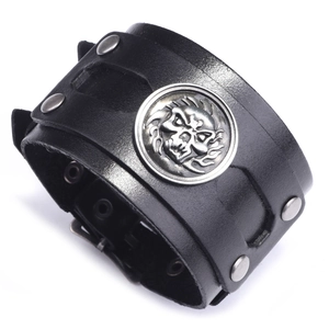 Punk style wide black leather wristband with silver skull shield and metal rivets