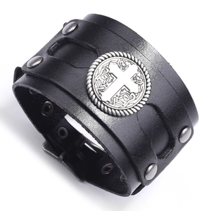 Punk style wide black leather wristband with silver cross emblem and metal rivets