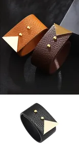 Detail of wide PU leather bracelet with gold triangular metal studs and snap closure