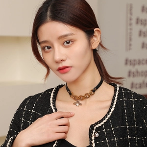Vintage PU leather choker featuring a golden bee pendant with a pearl inlay on a model