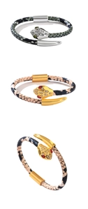 Macro shot of luxury snake-head bracelets with cubic zirconia pavé and textured snake skin bands