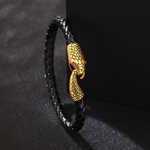 Men's black braided leather wrap bracelet featuring a golden snake head clasp with red eyes