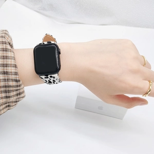 Detail of leopard print faux calf hair watch band for Apple Watch with gold rings