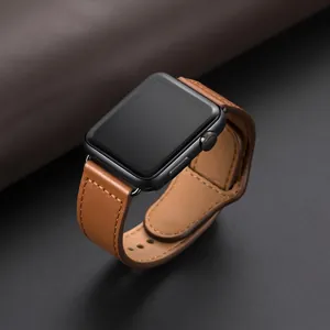 Classic brown leather band with stitching for Apple Watch on a dark textured background