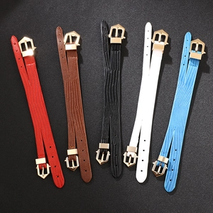 Five colored PU leather belts with snake texture and gold geometric buckles on black background