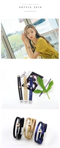 Close-up of multilayer leather bracelets with sparkling rhinestone star charms and clasps